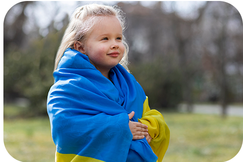 Image of a small Ukrainian Girl wearing a Ukrainian Flag